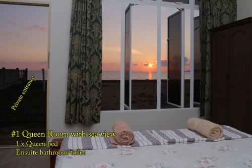 a room with a window with a view of the ocean at KC Beachfront in Marang