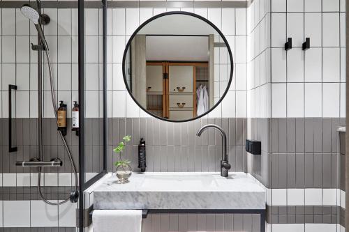 a bathroom with a sink and a mirror at PURO Warszawa Centrum in Warsaw