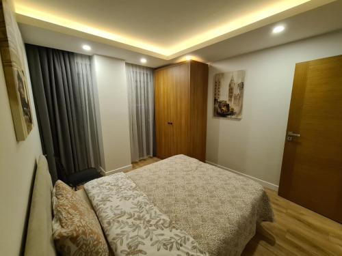 a small bedroom with a bed and a window at Veranda Suites in Antalya