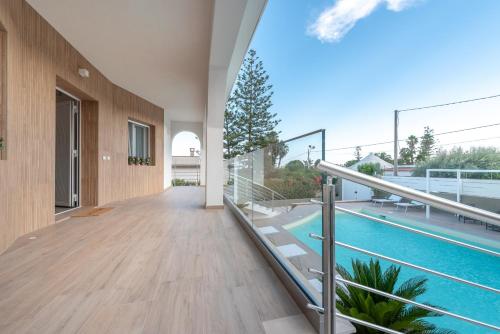 an empty hallway of a house with a swimming pool at Villa Livia - IsulaTravel in Fontane Bianche