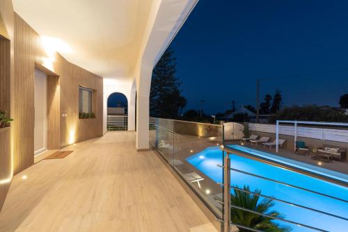 a house with a swimming pool at night at Villa Livia - IsulaTravel in Fontane Bianche