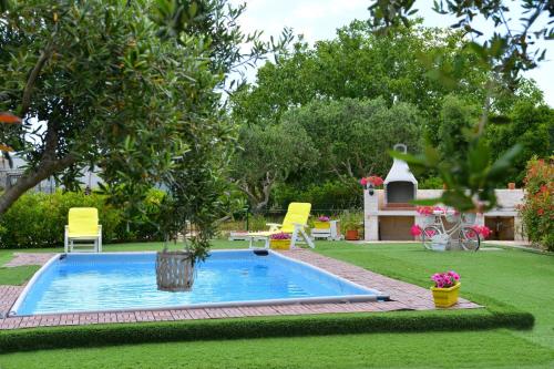 a swimming pool in the middle of a yard at Trullo Suite in Cisternino