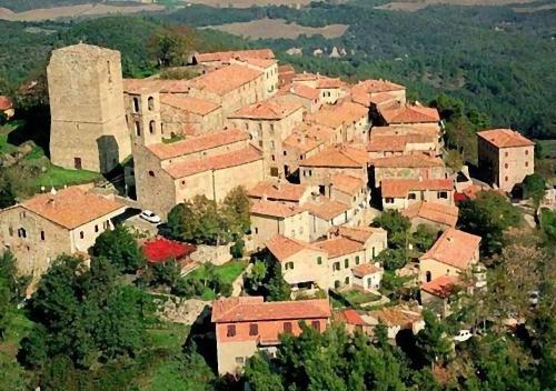 an aerial view of a small village with buildings at Tuscan Farmhouse with 7 Apartments for max 30 persons in Montecastelli Pisano