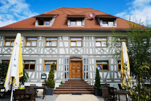 a house with two umbrellas in front of it at Hotel Adler Ittendorf in Ittendorf