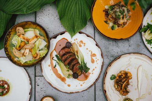 a group of plates of food on a table at PURO Łódź Centrum in Łódź