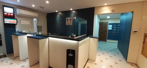 a lobby with a counter in a building at HOTEL ROTA DO SOL in Praia Grande