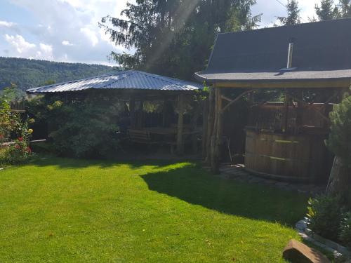 a house with a gazebo in a yard at Pokoje Gościnne u Gochy in Ustrzyki Dolne