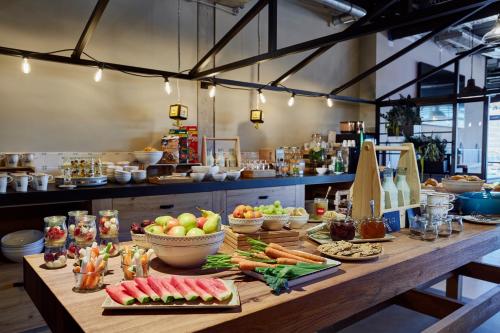 a table with fruits and vegetables on it in a kitchen at Me and All Hotel Kiel, by Hyatt in Kiel