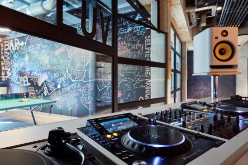 a kitchen with a stove top with a dj booth at Me and All Hotel Kiel, by Hyatt in Kiel