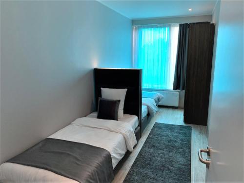 En eller flere senge i et værelse på Flat Hotel Midi 33