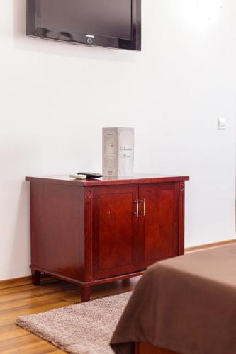 a wooden cabinet with a television on top of it at Lira Pacific Aparthotel in Constanţa