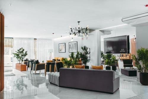 a living room with a couch and a flat screen tv at Masa Hotel 5 de Outubro in Lisbon