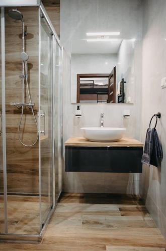 a bathroom with a sink and a shower at Little Home in Liptovský Mikuláš