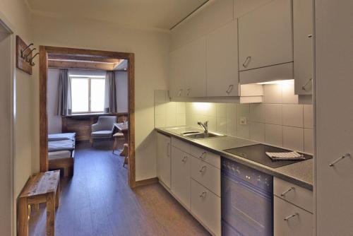 a kitchen with a sink and a counter top at Chesa Madrisa in St. Moritz