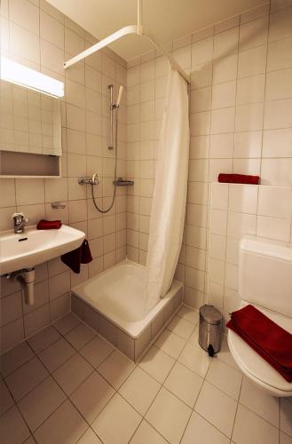 a bathroom with a shower and a toilet and a sink at Chesa Madrisa in St. Moritz