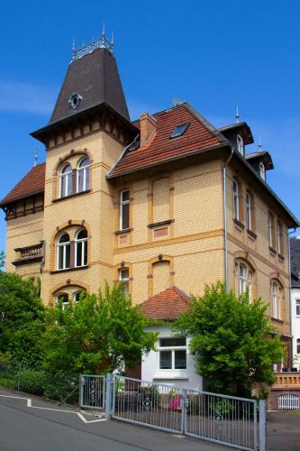 a large brick building with a roof at Ferienwohnung Hufelandstern bis 7 Personen - mit E-Ladesäule! in Bad Wildungen