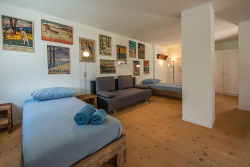a living room with two beds and a couch at Chesa Madrisa in St. Moritz