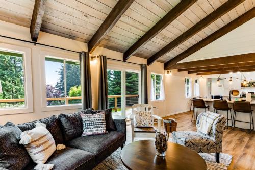 a living room with a couch and a table at Tall Cedars Cabin By The Water in Eastsound