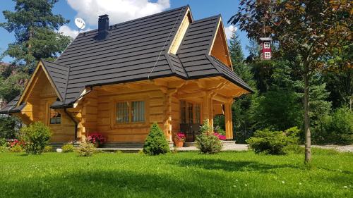 a log cabin with a gambrel roof at BIAŁY PUCH in Zakopane