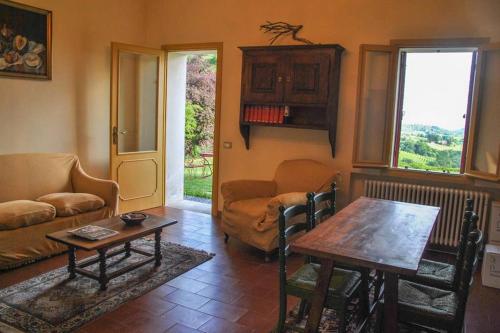 a living room with a table and a couch at La Torre di Rua in San Pietro di Feletto