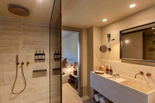 a bathroom with a shower and a sink and a toilet at Can Aulí Luxury Retreat - Adults Only in Pollença