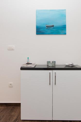 a white counter with a picture of a boat on the wall at Luxury Apartment Lukas Pool & Parking Vodice in Vodice
