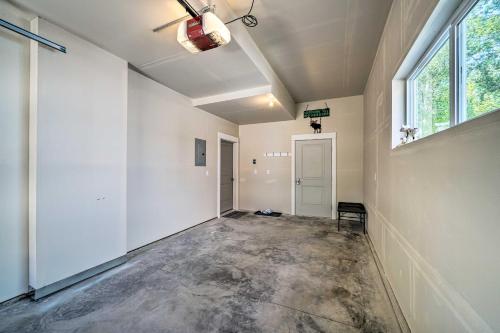 an empty room with a large window and a hallway at Bozeman Home with Deck Walk to Fishing, Hot Springs in Bozeman