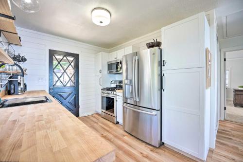 a kitchen with a stainless steel refrigerator and a stove at Modern Lake Michigan Home with 3 Lakefront Decks! in Holland