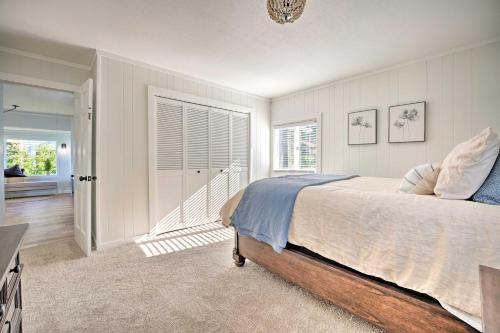 a bedroom with a large bed and a hallway at Modern Lake Michigan Home with 3 Lakefront Decks! in Holland