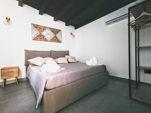 a bedroom with a bed with two pillows on it at Eremita Villa Sicily in Avola