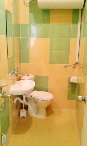 a bathroom with a toilet and a sink at АПАРТАМЕНТ LEO 4 in Varna City