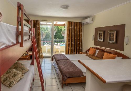 a bedroom with two bunk beds and a couch at DAMIA HOTEL Apts in Sidari