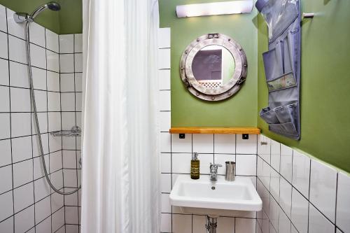 a bathroom with a sink and a mirror at Aris Athens Suites in Athens