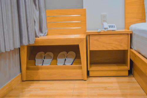 a pair of shoes in a cabinet in a bedroom at Mui Tau Hotel Phan Ri Cua in Tuy Phong