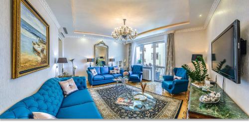 a living room with a blue couch and blue chairs at Center Residence 3 bedroom 3 bathroom in Budapest