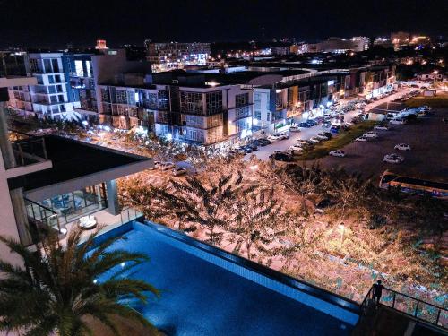 a view of a city at night with a swimming pool at Cat City Mediterranean Theme City&Pool View Homestay 貓城地中海主題城市泳池風景民宿 in Kuching