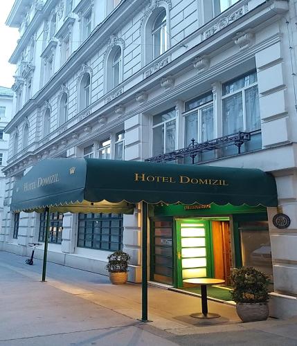 a hotel building with awning in front of it at Hotel Domizil in Vienna