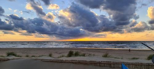 a view of the beach with a cloudy sky at Near the Beach in Zandvoort