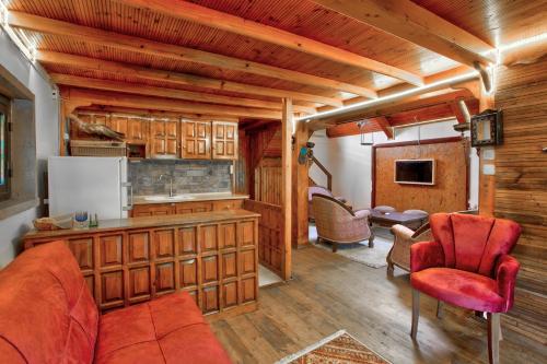 a kitchen and living room with red chairs and a couch at Paradise Plus Ağva in Agva