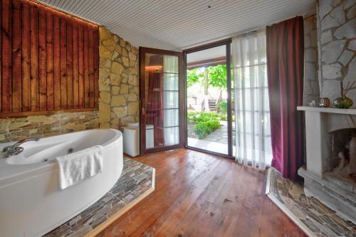 a large bathroom with a tub and a fireplace at Paradise Plus Ağva in Agva