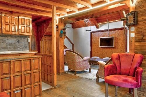 a living room with a red chair and a table at Paradise Plus Ağva in Agva