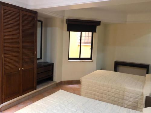 a bedroom with a bed and a window at Hostal Nordés in Oaxaca City