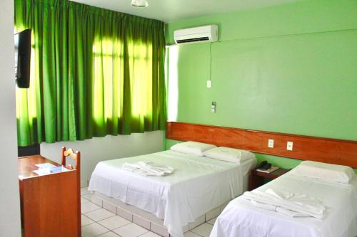 En eller flere senge i et værelse på Principe Hotel