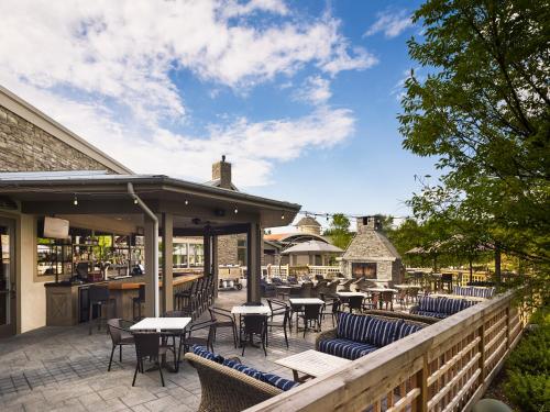 a patio with tables and chairs and a bar at The Inn at Chesapeake Bay Beach Club in Stevensville