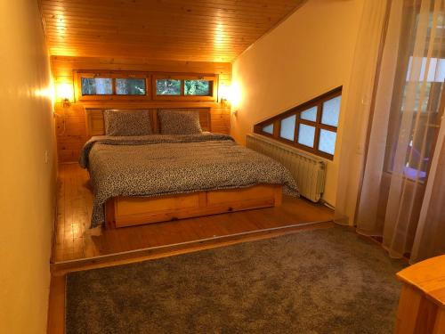 a bedroom with a bed and a window at Вила Пенчеви, кк. Цигов чарк in Tsigov Chark