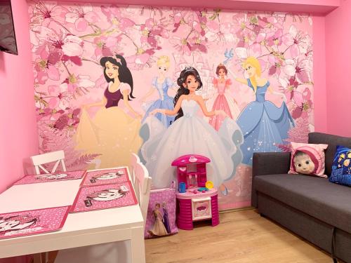 a room with a disney princess wall mural at Mese Panzió Zalakaros in Zalakaros