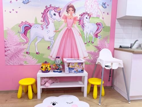 a childs kitchen with a princess and unicorn wall mural at Mese Panzió Zalakaros in Zalakaros