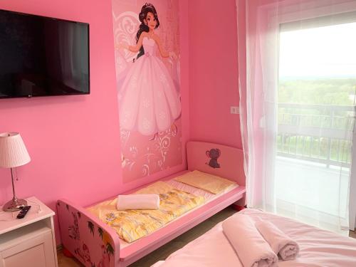 a bedroom with a barbie doll painting on the wall at Mese Panzió Zalakaros in Zalakaros