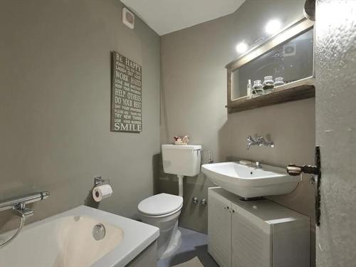 a bathroom with a sink and a toilet and a tub at Charmant petit appartement à Grimentz au pied des pistes in Grimentz