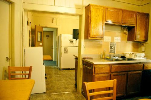 a kitchen with wooden cabinets and a white refrigerator at Little Tokyo Hotel in Los Angeles
